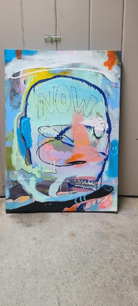 Abstract blue and pink face painting with Now text